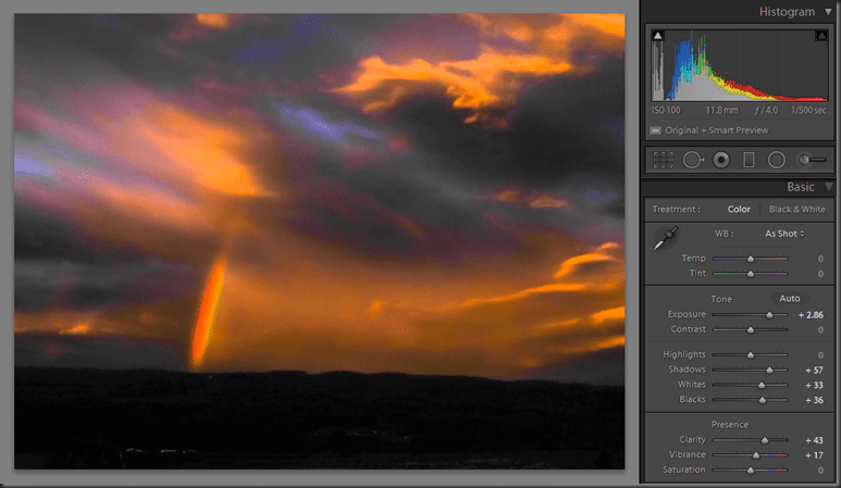 JPG image, showing some banding of colours and less detail in the sky than the RAW version, along with the develop settings and the histogram showing the combing that leads to the banding